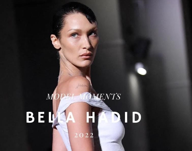 Bella Hadid na wybiegu, prezentująca kreację, ujęcie dynamiczne z pokazu mody, podkreślające jej karierę i siłę na scenie.